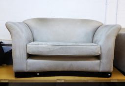 A CREAM SUEDE LARGE SETTEE, ON PLINTH BASE AND A TWO SEATER SETTEE ENSUITE (2)