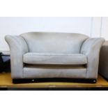 A CREAM SUEDE LARGE SETTEE, ON PLINTH BASE AND A TWO SEATER SETTEE ENSUITE (2)