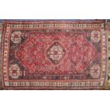 SHIRAZ, PERSIAN LARGE RUG with octagonal centre medallion, repeated in the spandrels, wine red and