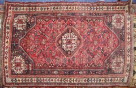 SHIRAZ, PERSIAN LARGE RUG with octagonal centre medallion, repeated in the spandrels, wine red and