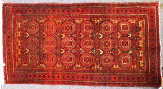 SHIRAZ PERSIAN RUG, with three tows of turkoman style stencilled guls, interspersed with seven pairs