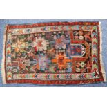 ANTIQUE DAGHESTAN PRAYER RUG, with two rows of three large formal flowers, on a midnight blue field,