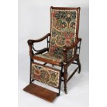 J FOOT & SON LTD, EARLY TWENTIETH CENTURY OAK RECLINING CHAIR, with folding foot rest and black