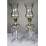 PAIR OF CLEAR GLASS ELECTRIC TABLE LAMPS MODELLED AS TABLE LUSTRES WITH STORM SHADES, each with