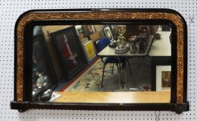 LATE VICTORIAN EBONISED AND MOULDED GILT GESSO OVERMANTLE MIRROR, the oblong plate with rounded