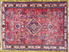 EASTERN CARPET, with small centre medallion and all-over floral and foliate scroll design on a