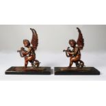 PAIR OF PATINATED BRONZE FIGURES OF WINGED PUTTO, each modelled playing a lyre and sat on a winged