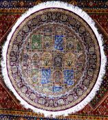 KIRMAN, PERSIAN, PART SILK CIRCULAR RUG, the centre section filled with a tile pattern, each tile