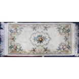 WASHED CHINESE EMBOSSED RUG with rose pattern centre medallion, floral and foliate scroll