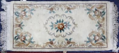 WASHED CHINESE EMBOSSED RUG with rose pattern centre medallion, floral and foliate scroll