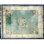 HEAVY QUALITY EMBOSSED WASHED CHINESE CARPET, with plain pale green field, with centre circular