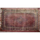 HERAT, PERSIAN LARGE RUG with centre medallion with pendants, red and all-over formal floral