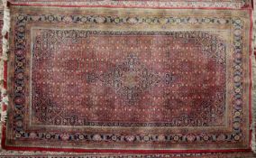 HERAT, PERSIAN LARGE RUG with centre medallion with pendants, red and all-over formal floral