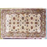 SMALL INDIAN CARPET, with all-over heratic style floral and foliate scroll design on an off-white