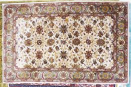 SMALL INDIAN CARPET, with all-over heratic style floral and foliate scroll design on an off-white