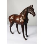 MODERN BROWN LEATHER MODEL OF A HORSE, 19 ½” (49.5cm) high, to the tip of the ears