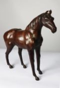 MODERN BROWN LEATHER MODEL OF A HORSE, 19 ½” (49.5cm) high, to the tip of the ears