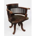 EARLY TWENTIETH CENTURY DARK STAINED FRUITWOOD REVOLVING DESK CHAIR, the shaped top rail above a