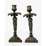 PAIR OF REGENCY STYLE PATINATED BRONZE FIGURAL CANDLESTICKS, each modelled as a standing Egyptian