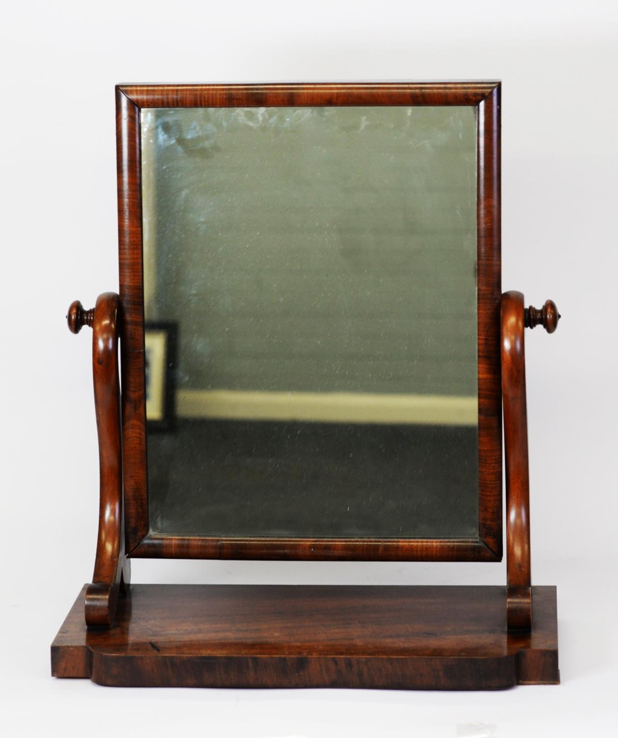 NINETEENTH CENTURY MAHOGANY TOILET MIRROR, WITH OBLONG PLATE, SCROLL SUPPORTS AND SHAPED OBLONG BASE