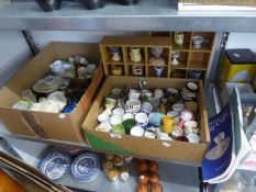 A LARGE COLLECTION OF MAINLY CERAMIC EGG CUPS  (SOME MODERN AND BOXED) AND TWO PINE DISPLAY RACKS
