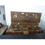 A LEATHER AND FIBRE BOUND CABIN TRUNK AND TWO LEATHER SUITCASES (3)