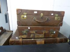 A LEATHER AND FIBRE BOUND CABIN TRUNK AND TWO LEATHER SUITCASES (3)