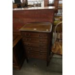 AN EDWARDIAN MAHOGANY INLAID MUSIC CABINET OF SIX FALL-FRONT DRAWERS