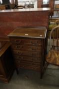 AN EDWARDIAN MAHOGANY INLAID MUSIC CABINET OF SIX FALL-FRONT DRAWERS