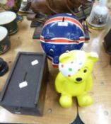 TWO POTTERY MONEY BOXES (UNION JACK AND PUDSEY BEAR), AND A WOODEN MONEY BOX AND TWO PLASTIC SHIP