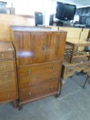 A GEORGE V MAHOGANY TALLBOY HAVING TWO CUPBOARD DOORS OVER THREE DRAWERS (A.F.)