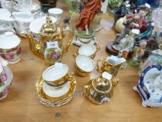 GERMAN GILT CHINA COFFEE SERVICE OF 15 PIECES, EACH PIECE PRINTED IN SMALL RESERVE WITH COURTIER AND