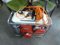 A HONDA PETROL RUN PORTABLE GENERATOR, MODEL E2500, WITH ELECTRIC CABLE AND MANUAL