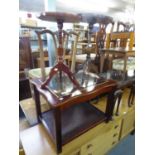 A MAHOGANY COFFEE TABLE WITH FRAMED BEVELLED PLATE GLASS TOP, WAVY OUTLINE AND CANE TOPPED