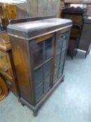 AN OAK GEORGE V TWO DOOR GLAZED BOOKCASE (A.F.)