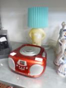 GROOVE’ PORTABLE RADIO/CD PLAYER AND A POTTERY FIGURE TABLE LAMP