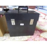 A VINTAGE BLACK VINYL RECORD STORAGE BOX, HOUSING A SMALL SELECTION OF MIXED GENRE VINYL RECORDS,