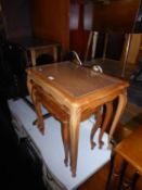 NEST OF THREE GLAZED CANEWORK TABLES