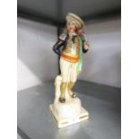 STAFFORDSHIRE POTTERY FIGURE OF A CONQUISTADOR, modelled with a pistol, on a gilt lined square base,