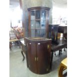 A GEORGE III OAK BOW FRONT CORNER CABINET (A.F.)