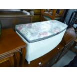 A WHITE LOOM OTTOMAN BOX WITH UPHOLSTERED LID AND A TRIPLE OVAL TOILET MIRROR, IN WHITE AND GILT