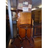 A TALL MAHOGANY PLANT STAND ON TRIPOD BASE AND A CARVED MAHOGANY TRIPLE WINE TABLE (2)