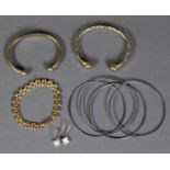 GOLD PLATED FANCY LINK BRACELET; TWO METAL TORQUE BANGLES; A SET OF FOUR METAL BANGLES AND A PAIR OF