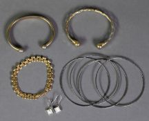 GOLD PLATED FANCY LINK BRACELET; TWO METAL TORQUE BANGLES; A SET OF FOUR METAL BANGLES AND A PAIR OF