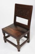ANTIQUE CARVED OAK SIDE CHAIR, with scroll carved panel to the back, solid seat and block and turned