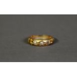 VICTORIAN 18ct GOLD RING with three small diamonds in star settings, chased ram's horn scroll