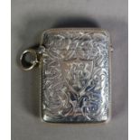 LATE VICTORIAN ENGRAVED SILVER VESTA CASE, of typical form with ring suspension, decorated with