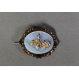 VICTORIAN OVAL MOONSTONE BROOCH overlaid with a gold foliate spray set with three oval white stones,