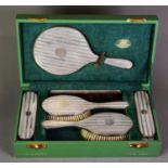 GEORGE V ENGINE TURNED SILVER BACKED AND CASED SIX PIECE DRESSING TABLE HAND MIRROR AND BRUSH SET,
