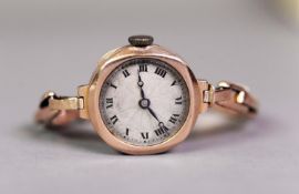 LADY'S 9ct GOLD CASED WRISTWATCH with Swiss movement, circular silvered roman dial and gold plated